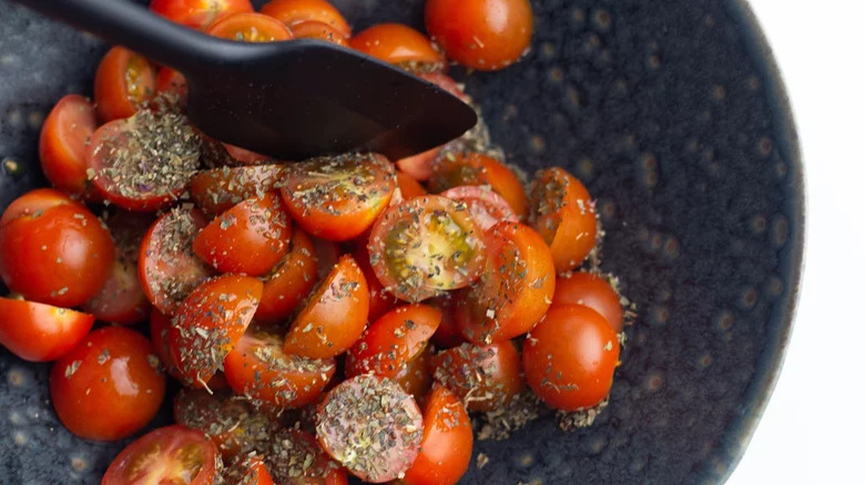 Cherry tomatoes with seasoning in bowl