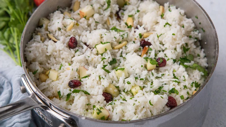 Rice with nuts and cranberries in pan