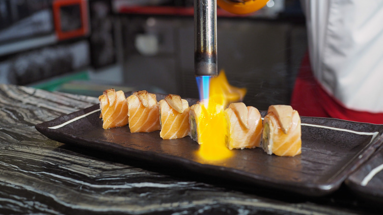 Aburi sushi torch flame on maki roll