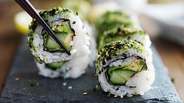 Avocado sushi roll and chopsticks