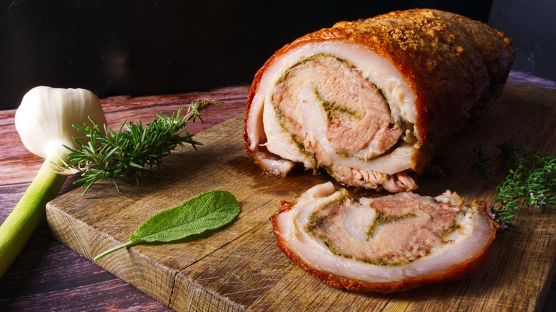 porchetta sliced on cutting board