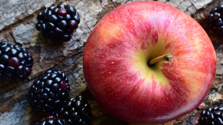 an apple and blackberries