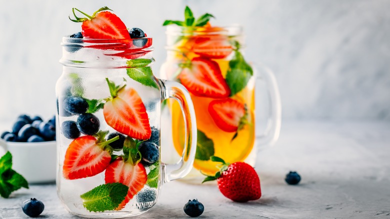 strawberries and blueberries in water