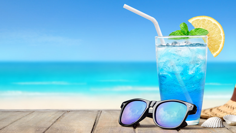 Blue drink with sunglasses on beach