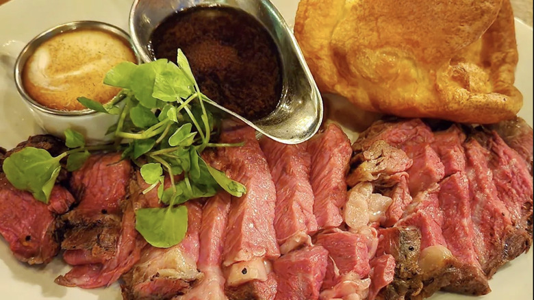 Steak with braed and sauce in gravy boat