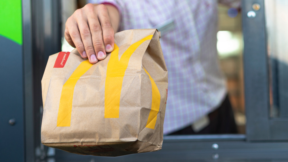 McDonald's drive-thru attendant serving food