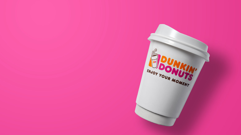 Dunkin' cup on pink background