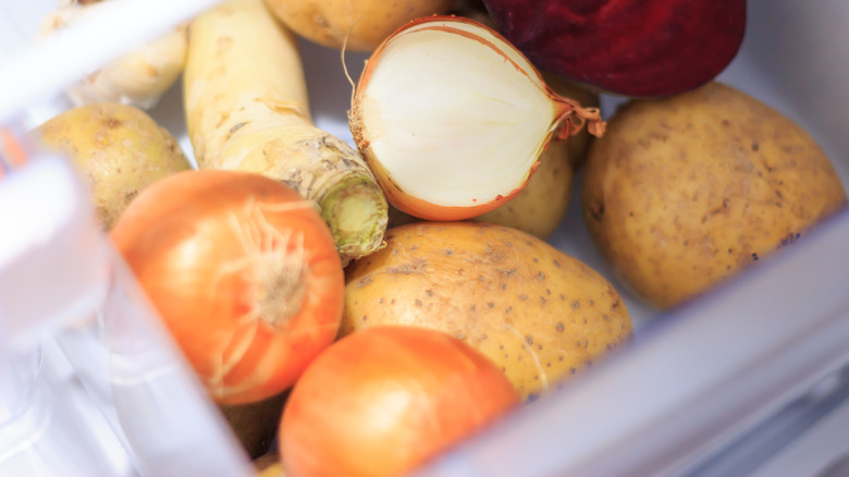 onion with vegetables in fridge drawer