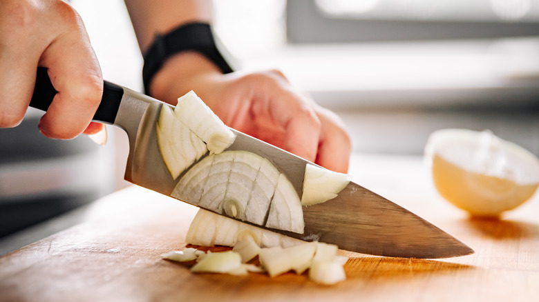 slicing onion with big knife