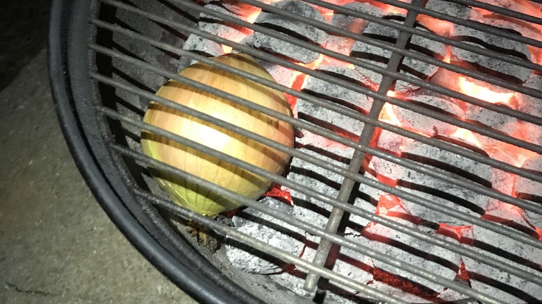 whole onion on barbecue coals