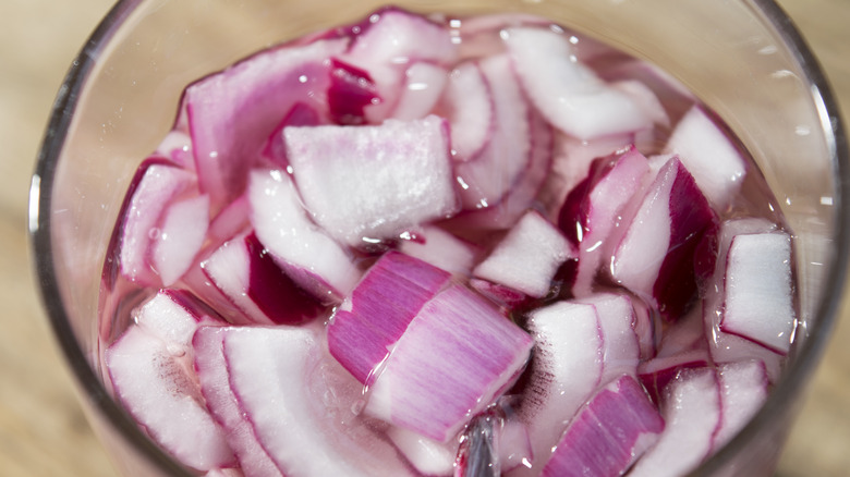 red onions diced in water in a bowl