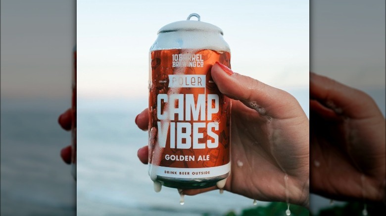 10 Barrel Camp Vibes beer can in hand foam water