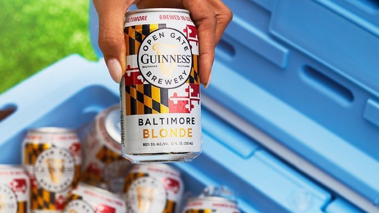 Guinness Baltimore Blonde beer in hand blue cooler