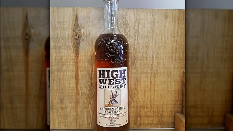 single bottle of High West Whiskey American Prairie Bourbon against a wooden background