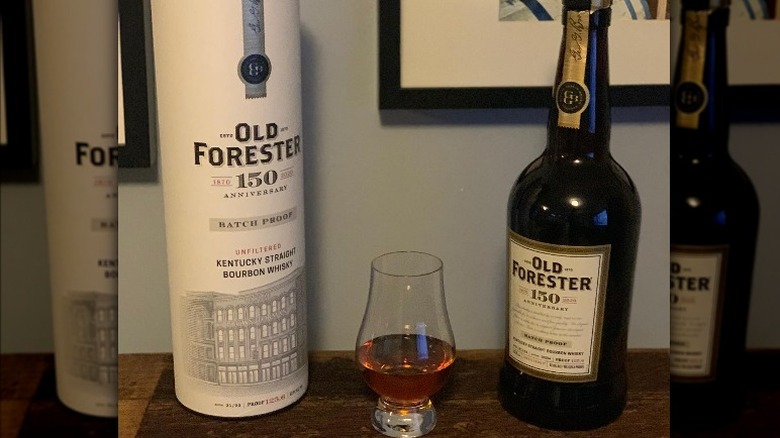 Old Forester cylindrical tube, whiskey glass, and bottle  