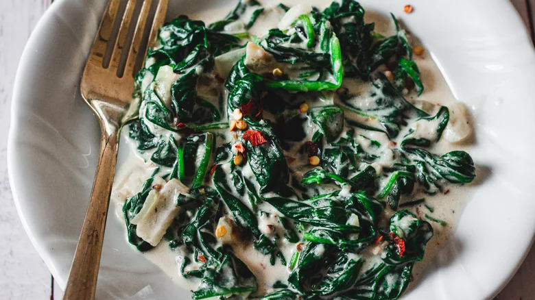 bowl of creamed spinach with fork