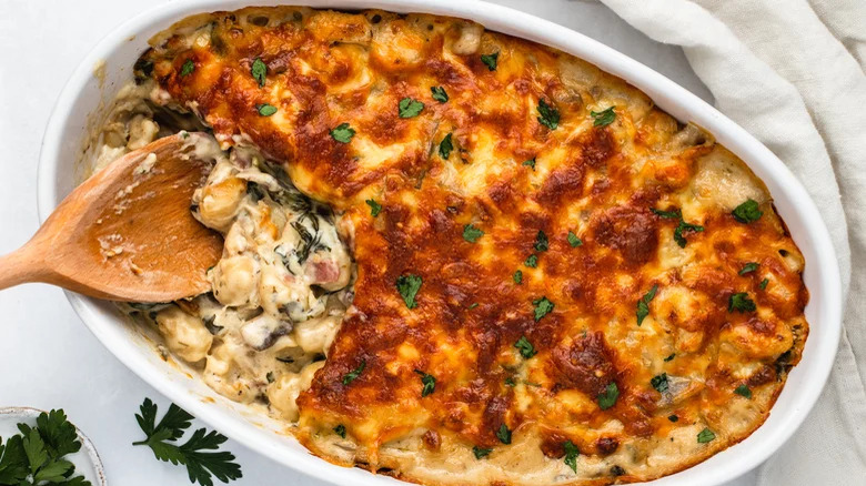 dish with creamy gnocchi bake and wooden spoon
