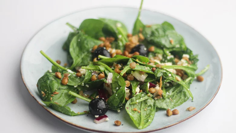 plate with lentil and spinach salad