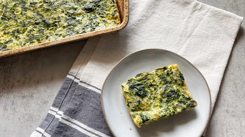 pan and plate with sliced spinach and cottage cheese pie