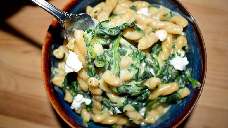 bowl of Spinach and Feta Mac and Cheese with fork