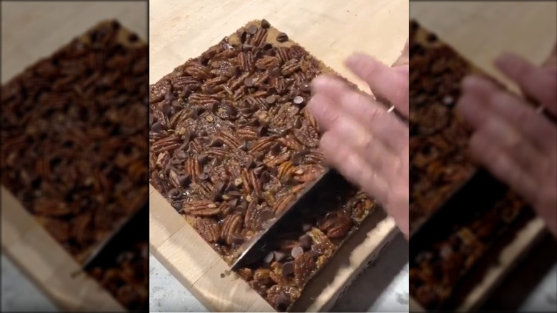 Caramel pecan bars with knife