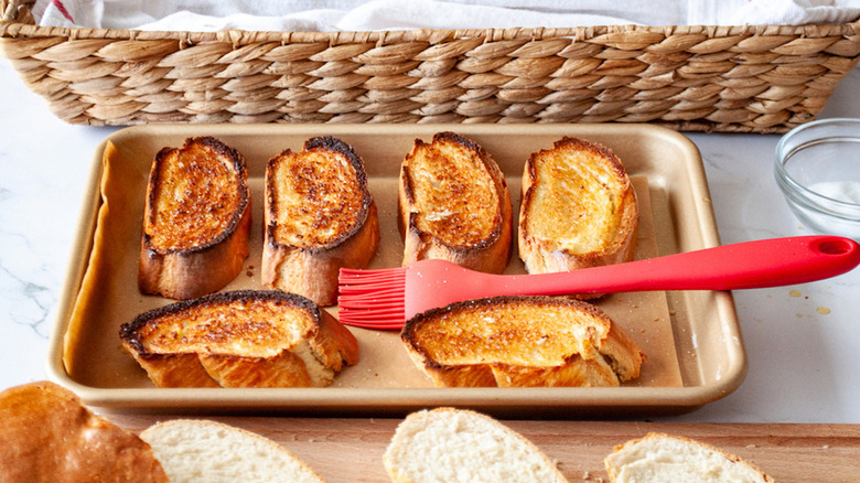 Toasted baguette slices with pastry brush