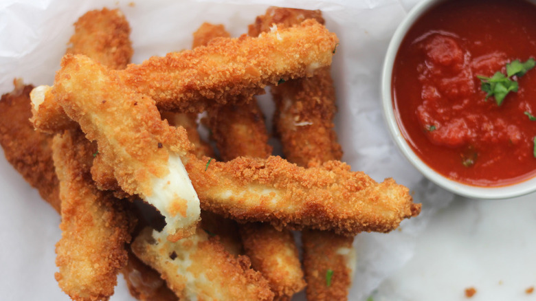 Breaded mozzarella sticks with tomato dip