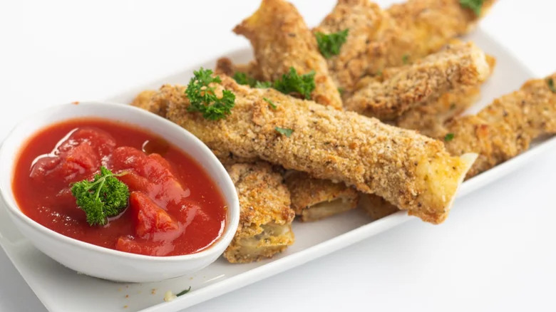 Cheesy breadcrumbed sticks with tomato dip