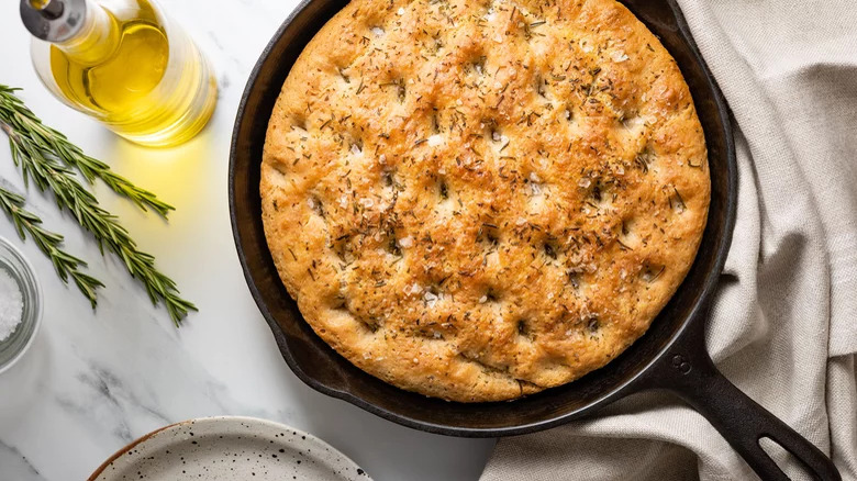 Focaccia bread with rosemary in cast iron skillet