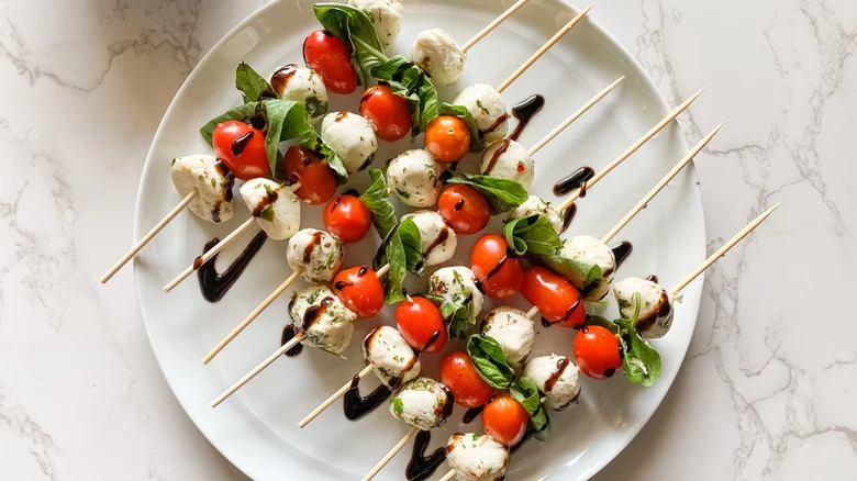 Mozzarella ball, grape tomato, and basil skewers