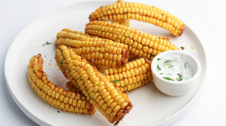 Strips of corn kernels on a plate with sauce