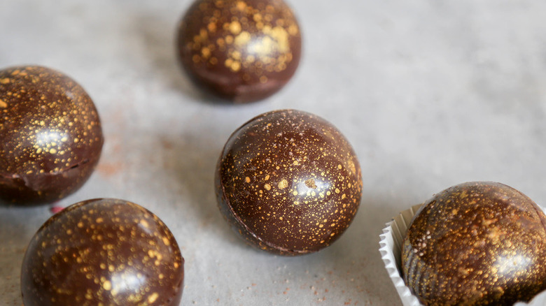 Chocolate spheres speckled with gold