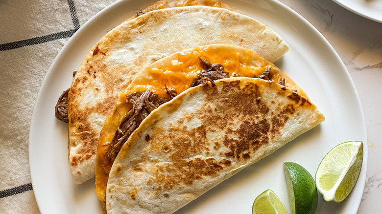 Quesadillas with beef and lime wedges