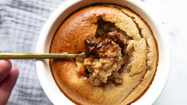 Small bowl and spoonful of baked cake