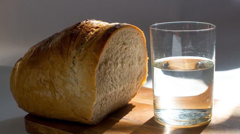 loaf of bread with glass of water