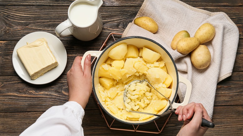 mashed potatoes with milk and butter and masher