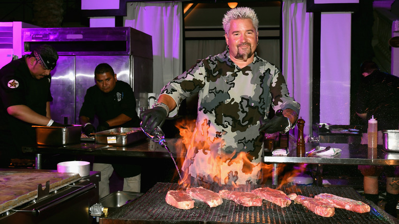 Guy Fieri grilling meat