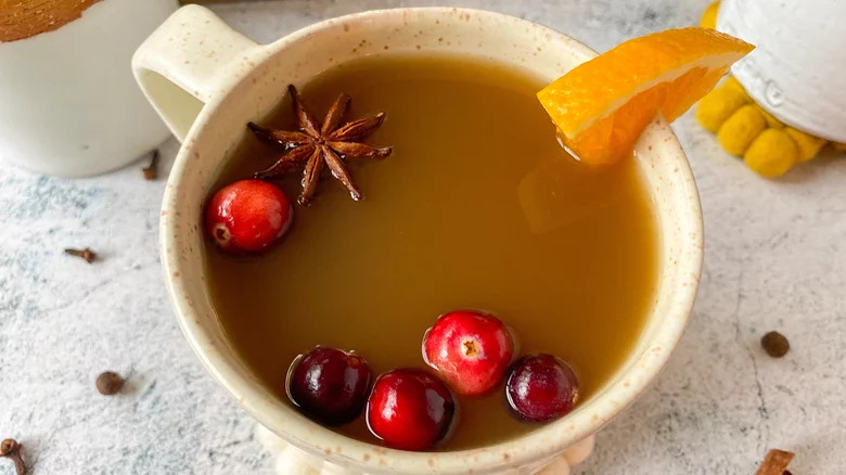 Apple cider with oranges, cranberries, and spices