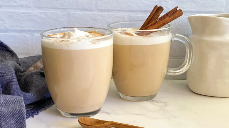 Two cups of chai with cinnamon sticks