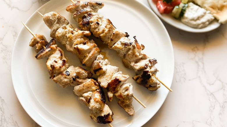 Greek chicken souvlaki skewers on plate