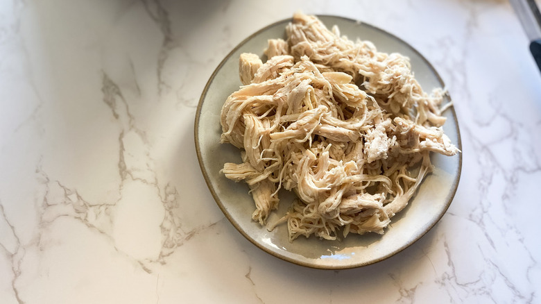 Shredded cooked chicken on plate