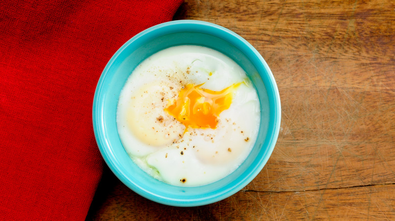 A coddled egg in a small blue dish