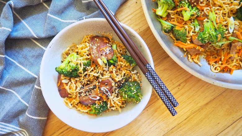 Beef and broccoli noodles with chopsticks