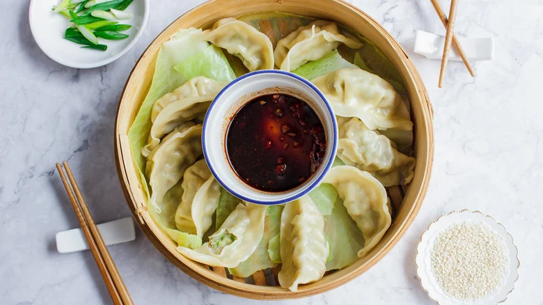 Dumplings with soy sauce dip and chopsticks