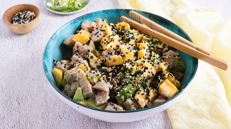 Tuna poke bowl with mango, soy sauce, and avocado