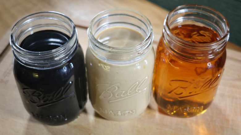 jars of coffee liqueur, cream liqueur, and whiskey in a row