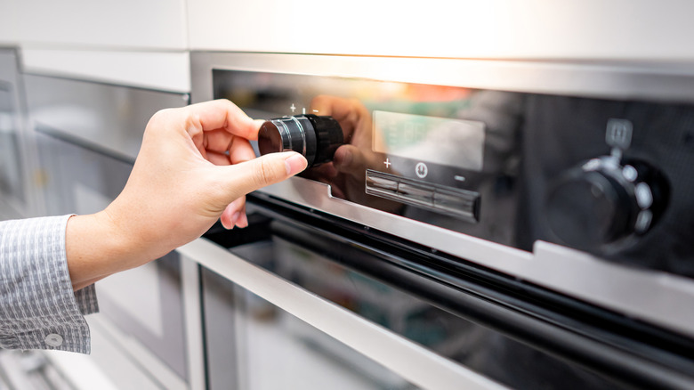 woman preheating oven