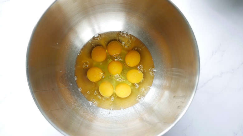 Raw eggs in mixing bowl