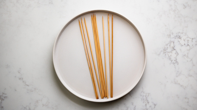 wooden skewers on white plate