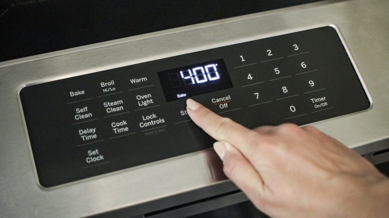 hand touching oven